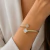 Bracelete Aro Duplo com Zircônia Cravejada Trevo na Ponta ( Folheado a Ouro 18K e Ródio )