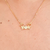Colar com 2 meninos cravejado com zircônias banhado em ouro 18k