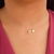 Colar fio de nylon e letra E banhado em ouro 18k