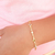 Pulseira infantil com pedrinhas coloridas e pérolas banhada em ouro 18k