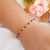 Pulseira com pedrinhas pretas banhada em ouro 18k