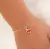 Conjunto infantil com brinco e pulseira coração rosa banhado em ouro 18k na internet
