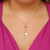 Colar gravatinha com ponto de luz e letra M banhado em ouro 18 k
