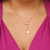 Colar gravatinha com ponto de luz e letra T banhado em ouro 18 k