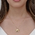 Colar gargantilha com pingente de estrela lisa com moldura cravejada com micro zircônias coloridas Banhado em ouro 18k