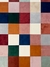 Tapete geométrico com padrão de quadrados em várias cores, incluindo azul marinho, terracota, off-white, verde, verde claro, bordô, granito, rosé gold, bege, cobre e nude rosado.