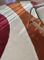 Tapete redondo em nylon nas cores cobre, vinho, off-white e terracota, Tapetes São José