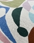 Tapete de nylon com padrão colorido abstrato em tons de verde, azul, lilás e marrom.