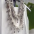 Colar quilombolas de São Lourenço, feito com cordão trançado e contas ornamentais.