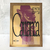 Quadro decorativo da obra "Carrranca" de Thiago Barletta, com uma composição artística em tons de roxo e amarelo.