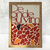 Imagem do produto "De Onde eu Vim" de Thiago Barletta, apresentando uma moldura de madeira e um design gráfico com texto em vermelho e um padrão colorido de pedras.