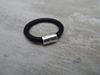 ANILLO DE CUERO CON DONA DE PLATA