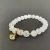 Pulseira De Pedra Natural Selenita com olho grego dourado na internet