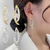 Aritos De Mujer Cruz Curvada Strass Delicado - comprar online
