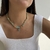 Colar Orgânico Dente Azul /Dourado - comprar online