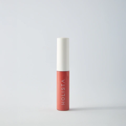 Blush Skincare tono coral rosado de la marca Holista, presentado en envase cilíndrico moderno con tapa blanca.