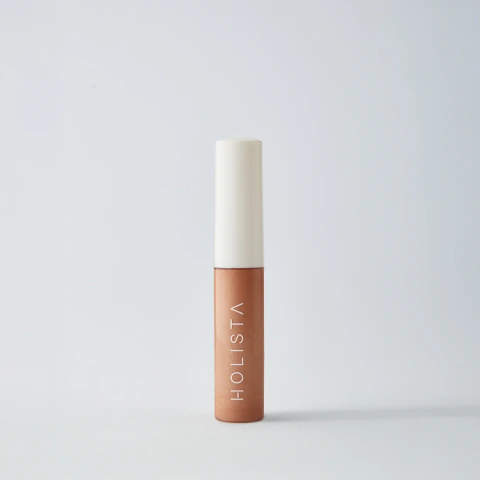 Iluminador facial Skincare Highlighter tono Peach de Holista, en envase pequeño con tapa blanca, ideal para resaltar y cuidar la piel.