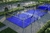 Cancha de padel Classic Llave en mano PADELAR con superficie azul y estructura metálica, rodeada de vegetación.