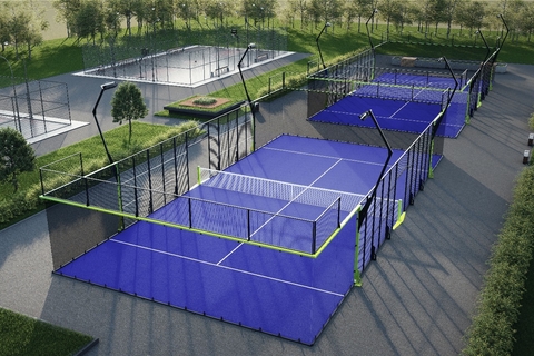 Vista aérea de varias canchas de padel con superficie azul y estructuras modernas.