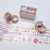 Rollos de cinta adhesiva decorativa con diseños coloridos de animales y frutas, en una mesa blanca.