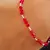 Pulsera elastizada cristales rojos y bolitas de plata en internet
