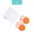 Kit de absorventes para seios Happy Flute com estampa laranja e um saco de armazenamento branco.