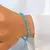 PULSERA ELASTIZADA DE CRISTALES DE ROCA BICONO (GAMA COLORES CELESTES/VERDES) - comprar online