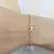 PULSERA CON BOLITAS Y ROMBOS RAYADOS - comprar online