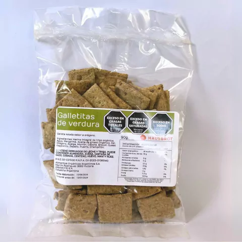 Paquete de galletitas integrales de verdura y orégano, con etiqueta informativa sobre ingredientes y valores nutricionales.
