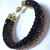 Pulseira dupla, 2cm largura, em crochê fio metal e vidrilhos tchecos preto e dourado, fecho magnético, 19,5cm. na internet