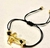 Pulseira/Tornozeleira, dourada Crucifixo regulável.