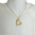 Colar Folheado a Ouro - Coração de lado metade liso + Metade textura - comprar online