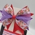 Conjunto infantil laço + kit de pulseiras - Flores vermelha com laço Roxo e transparente na internet