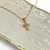Colar Folheado a ouro - crucifixo entre meio pedrinhas zircônia - comprar online