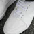 Zapatillas blancas de la marca Mita, modelo Trust One con detalles de textura en la parte superior y cordones blancos.