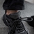 Primer plano de una zapatilla negra con detalles en la parte superior y cordones desatados.