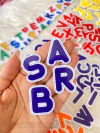 APLIQUE EM ACRILICO LETRAS PESPONTADAS AZUL A UNIDADE