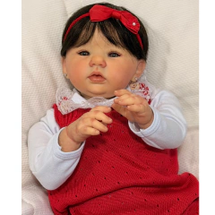 Bebê reborn realista menina com vestido vermelho e faixa de cabelo vermelha, feito à mão. Artesã Ana Dolls.