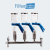 MANIFOLD PARA FILTRAÇÃO COM 3 LUGARES, BASE TOTALMENTE EM AÇO INOXIDÁVEL E RESERVATÓRIO (COPO) EM VIDRO BOROSSILICATO COM CAPACIDADE PARA 300 ML, SEM TAMPA. MODELO: MFV-3