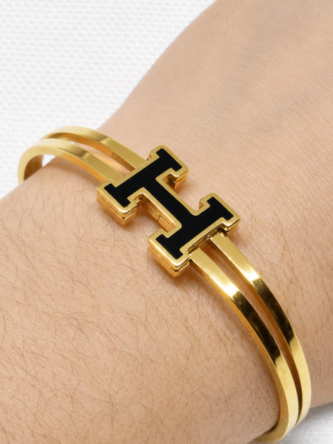 Pulsera de rígida acero dorado (Hermes)
