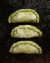 Empanadas freezadas rellenas de Lomito de cerdo, cebolla y queso originales de ASADO FEROZ, listas para hornear. La masa es casera con harina orgánica, pigmentada color verde de forma natural.