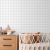 Papel de parede infantil com estampa xadrez vichy cinza em um quarto minimalista.