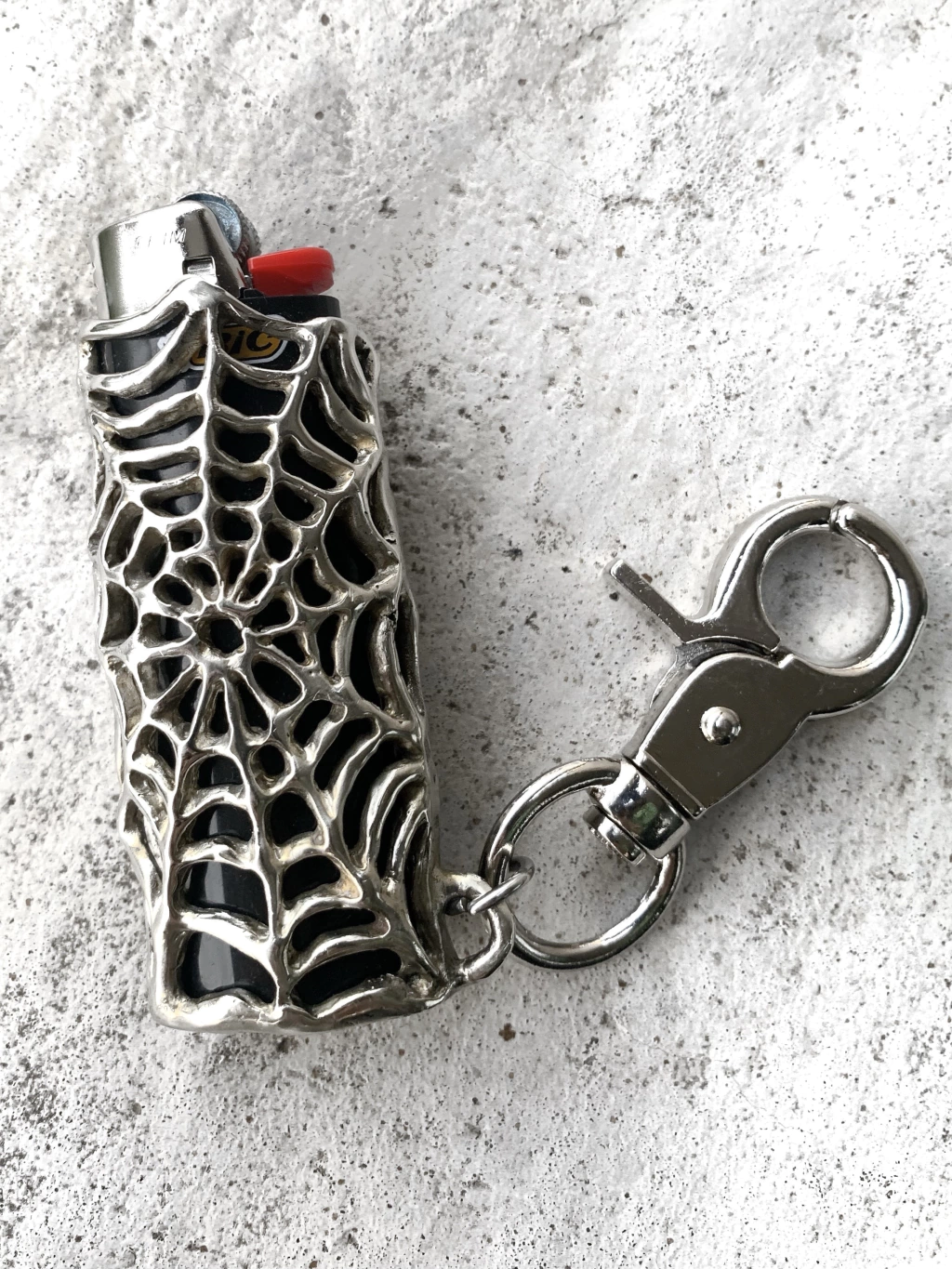 tela de araña porta encendedor