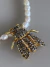 Imagem do Colar animal print dourado verniz italiano com pérola de água doce e strass linha premium