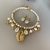 conjunto Sereia Búzio Dourado pedras e strass na internet