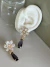 Brinco dourado linha festa Zircônia cristal com pedra gota Roxo tipo ametista e pino com flor cristal - Bia Pimenta acessorios 