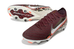 Chuteira de futebol campo Nike Air Zoom Mercurial Vapor 16 Elite com trava mista SG em tons de vermelho, laranja e preto com detalhes estampados