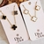 Conjunto de Colar e Brincos Trevo Preto ou Branco Banhado a Ouro 18k - comprar online