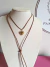 Colar Courinho Marrom- Pingente Coração em Aço Dourado - comprar online