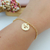 PULSEIRA COM MEDALHA FAMÍLIA VAZADA BANHADA A OURO 18K